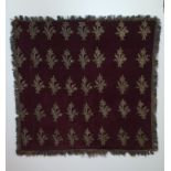 A 19th century Ottoman plum velvet textile embroidered with a repeating floral design in silver