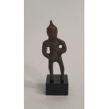 An early bronze figure of a deity on a stand. H.8.5cm