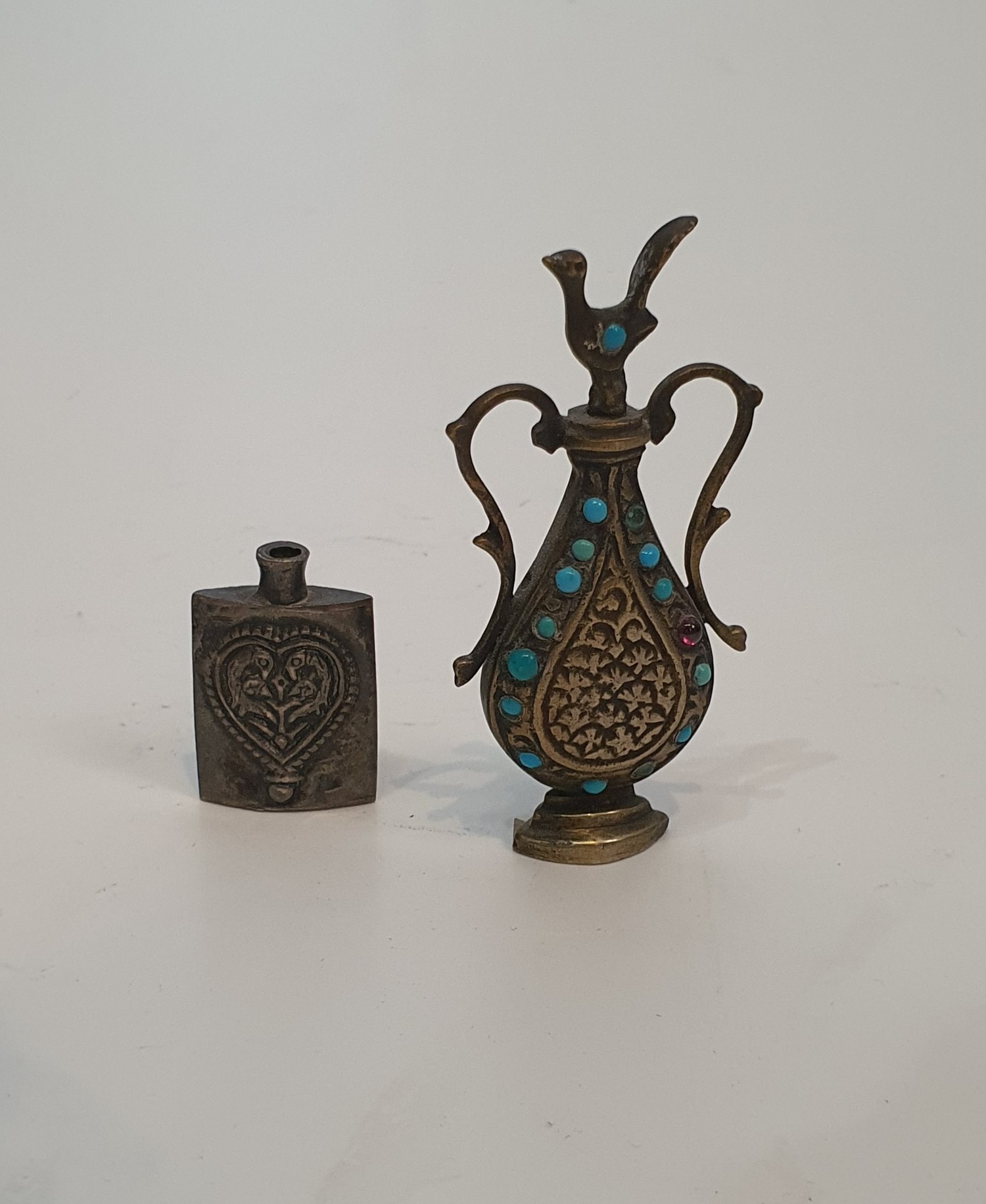 An Islamic hinged brass box with clasp engraved with a stylised calligraphy design along with two - Image 5 of 6