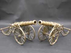 A pair of large table models of field canons with brass barrels and carriages. H.40 L.41 W.11cm