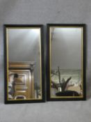 A pair of late 19th century oak wall mirrors in moulded oak frames with gilt slips. H.79 W.40cm