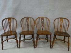 A set of four 19th century elm stick back dining chairs with pierced back splats on turned