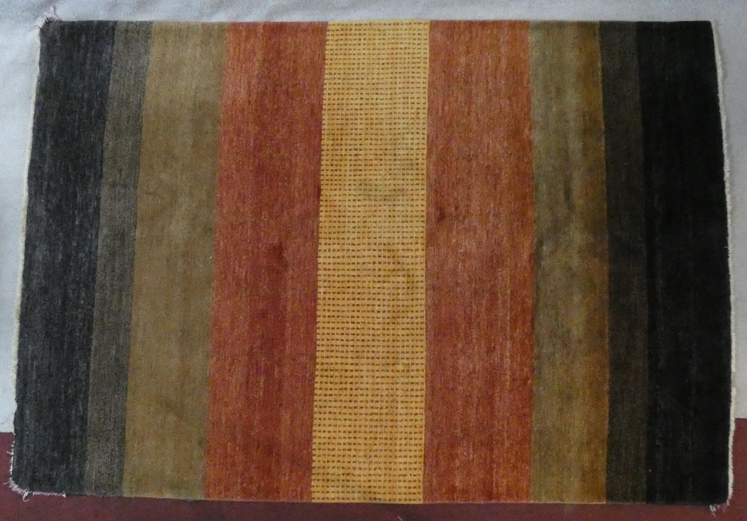 A woollen carpet with polychrome bands. L.250 W.170cm