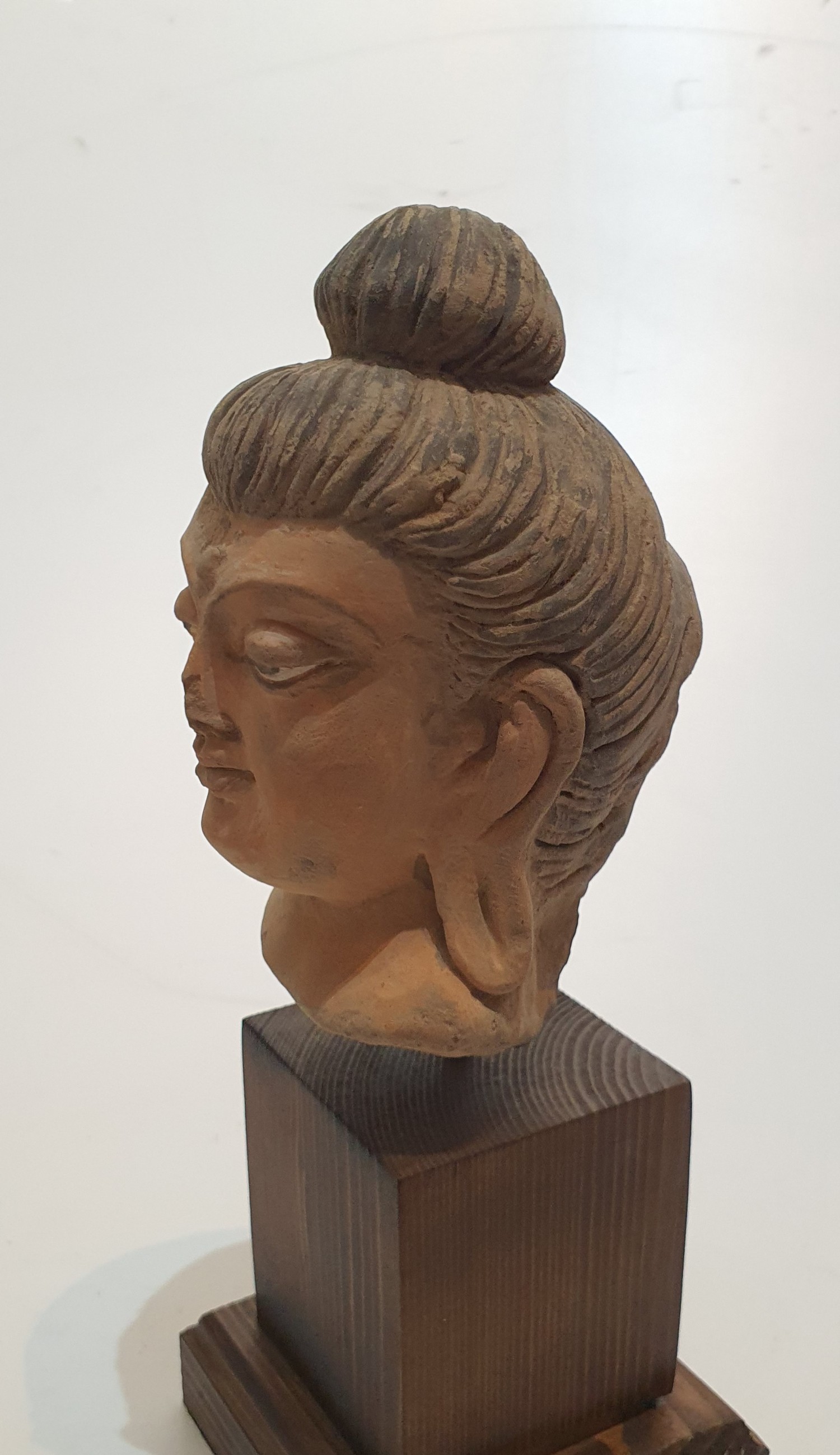 A Chinese terracotta head of buddha with painted details, mounted on a wooden stand. H27cm. - Image 4 of 4