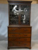 A Georgian mahogany secretaire bookcase with dentil and blind fret cut cornice above astragal glazed