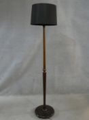 A vintage mahogany standard lamp on turned and facetted column on platform base. H.174cm