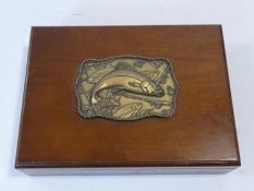 A wooden fishing tackle box with embossed plaque with trout along with an optician's Ultra Lense and