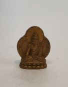 A Tibetan gilded bronze buddha with ray of light behind. H.7cm