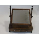 A Georgian mahogany swing toilet mirror fitted with original plate on bowfronted base with two