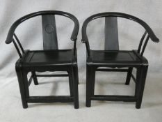 A pair of antique Chinese hardwood hooped back armchairs on rounded stretchered supports. H.90cm