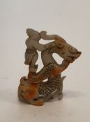 A Chinese pierced white jade carving of a dragon with a man riding on its back. H.8cm