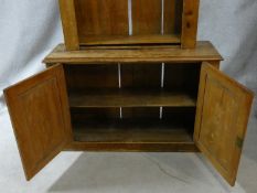 A 19th century pine bookcase with pokerwork vine leaf decorated arched pediment and open upper