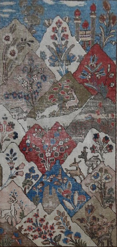 An antique Persian pictorial rug with animals and foliage in a mountain setting within stylised - Image 2 of 4