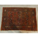 A Shirvan rug with repeating gul motifs across the madder ground contained by multiple stylised