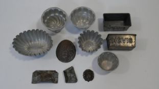 A collection of eleven antique and vintage metal chocolate, bread and jelly moulds. Including a