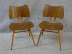 A pair of mid century vintage Ercol butterfly chairs with laminated plywood back and seats on