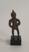 An early bronze figure of a deity on a stand. H.8.5cm