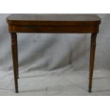 A 19th century mahogany and satinwood strung foldover top tea table on turned tapering supports. H.
