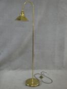 A brass floor standing adjustable lamp. H.147cm