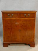 A Georgian style yew and crossbanded side cabinet. H.80 W.72 D.41cm