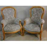 A pair of 19th century style beech framed armchairs in cut floral velour upholstery on carved
