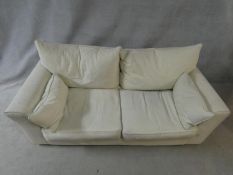 A Collins and Hayes two seater sofa in off white calico upholstery on block feet. H.71 L.200 D.95cm