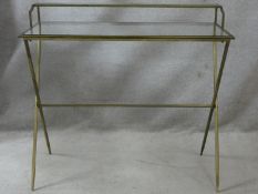 A gilt metal framed Maison Jansen style writing table with raised plate glass superstructure and top