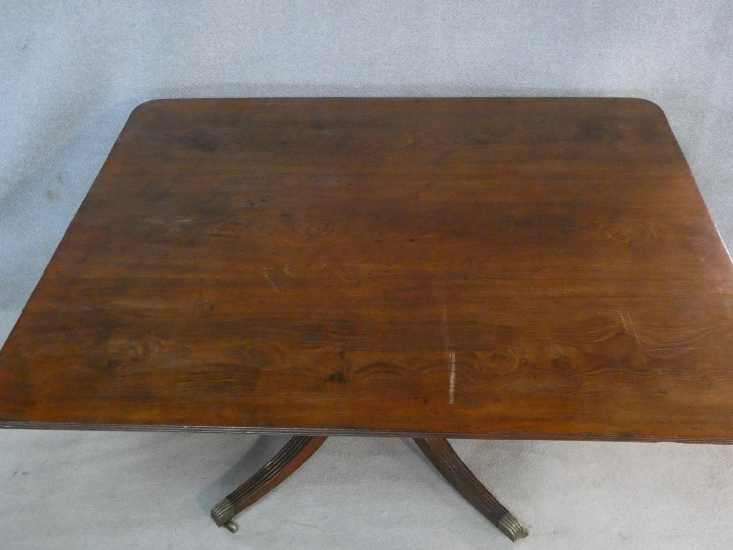 A Regency mahogany tilt top dining table on reeded swept quadruped supports terminating in brass cap - Image 2 of 4