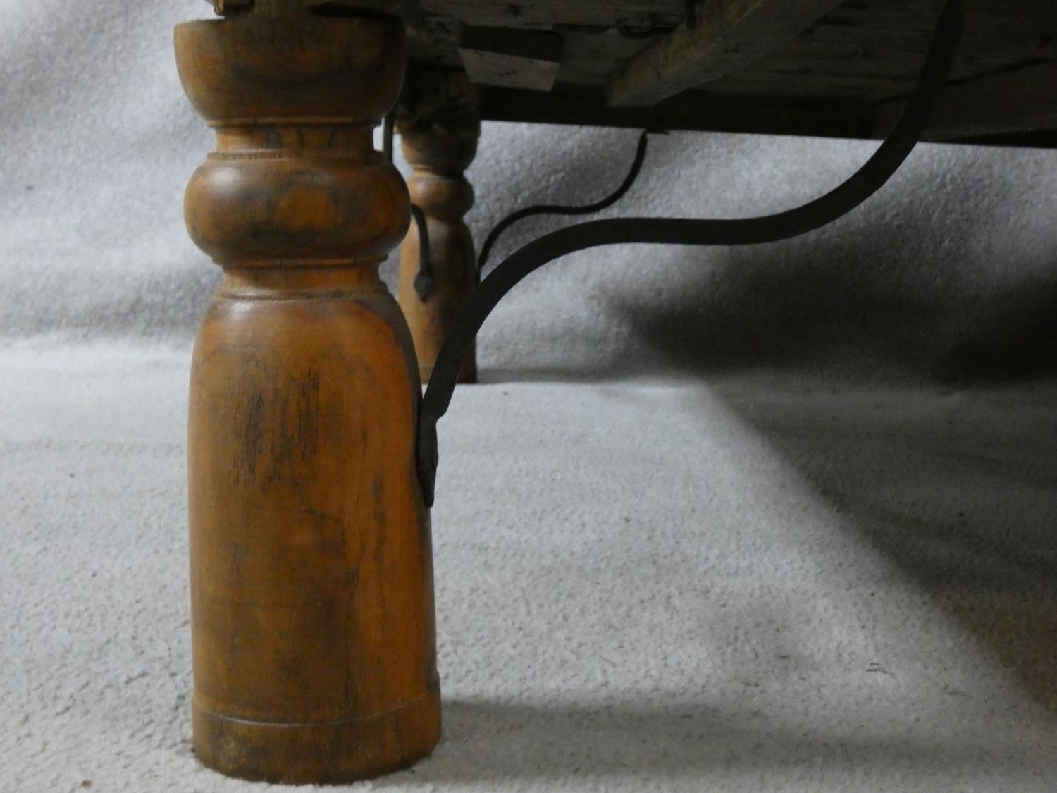 An Indian brass bound hardwood coffee table from a pair of antique studded and panelled doors with - Image 3 of 9