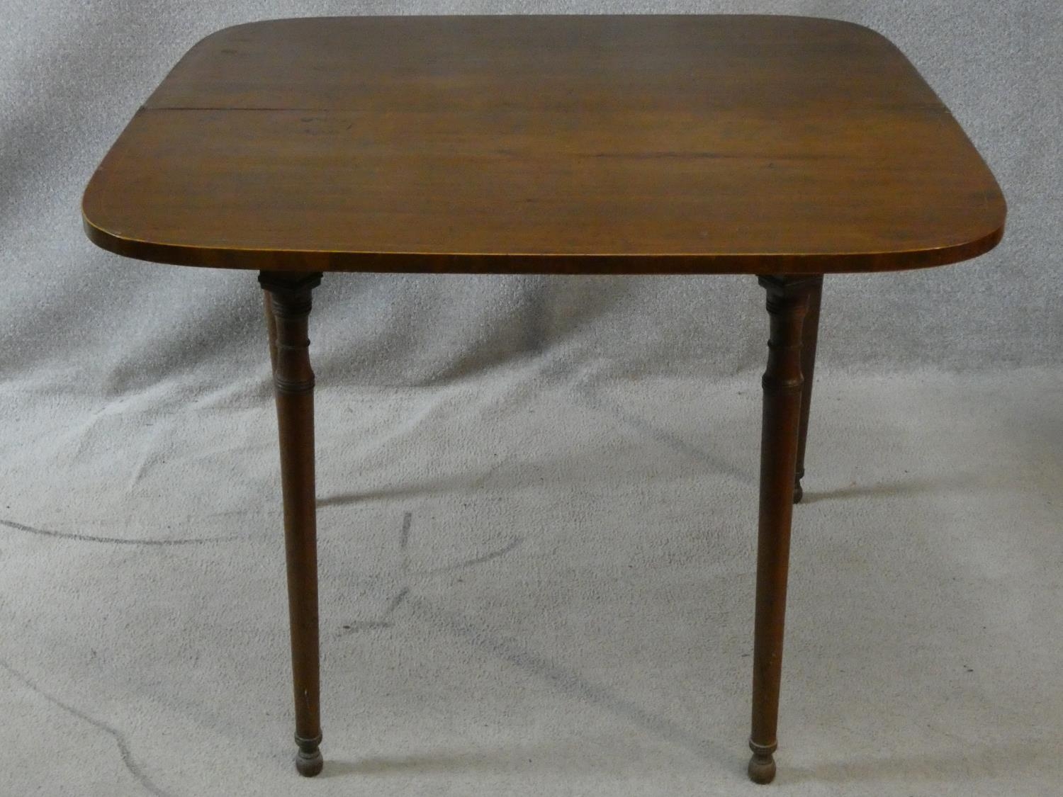 A 19th century mahogany and satinwood strung foldover top tea table on turned tapering supports. H. - Image 2 of 3