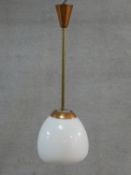 A mid century vintage copper ceiling pendant lamp with globular milk glass shade. H.83cm