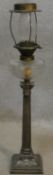 A tall late 19th century oil lamp with cut crystal reservoir standing on a silver plated