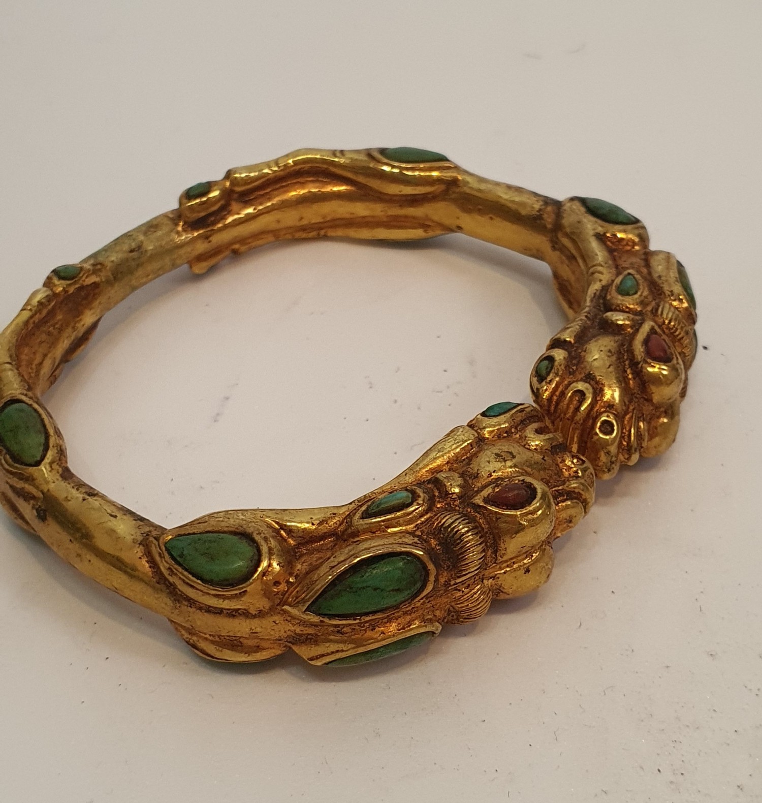 A Tibetan gilded bronze two headed dragon bangle inset with turquoise and red stone cabochons for - Image 3 of 3