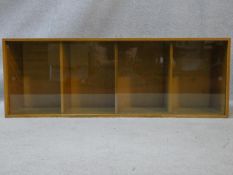 A mid century vintage teak Unix sectional bookcase with twin glass sliding doors and maker's