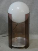 A vintage globe lamp on smoked perspex frame fitted with aluminium undertier. H.77cm