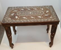 An antique Indian side table inlaid with with ivory on elephant head shape supports. The table has a