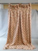 A pair of stylised floral design linen, lined curtains with repeating diamond pattern in cream, gold