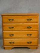 A 19th century style pine chest of four long drawers. H.84 W.86 D.44cm