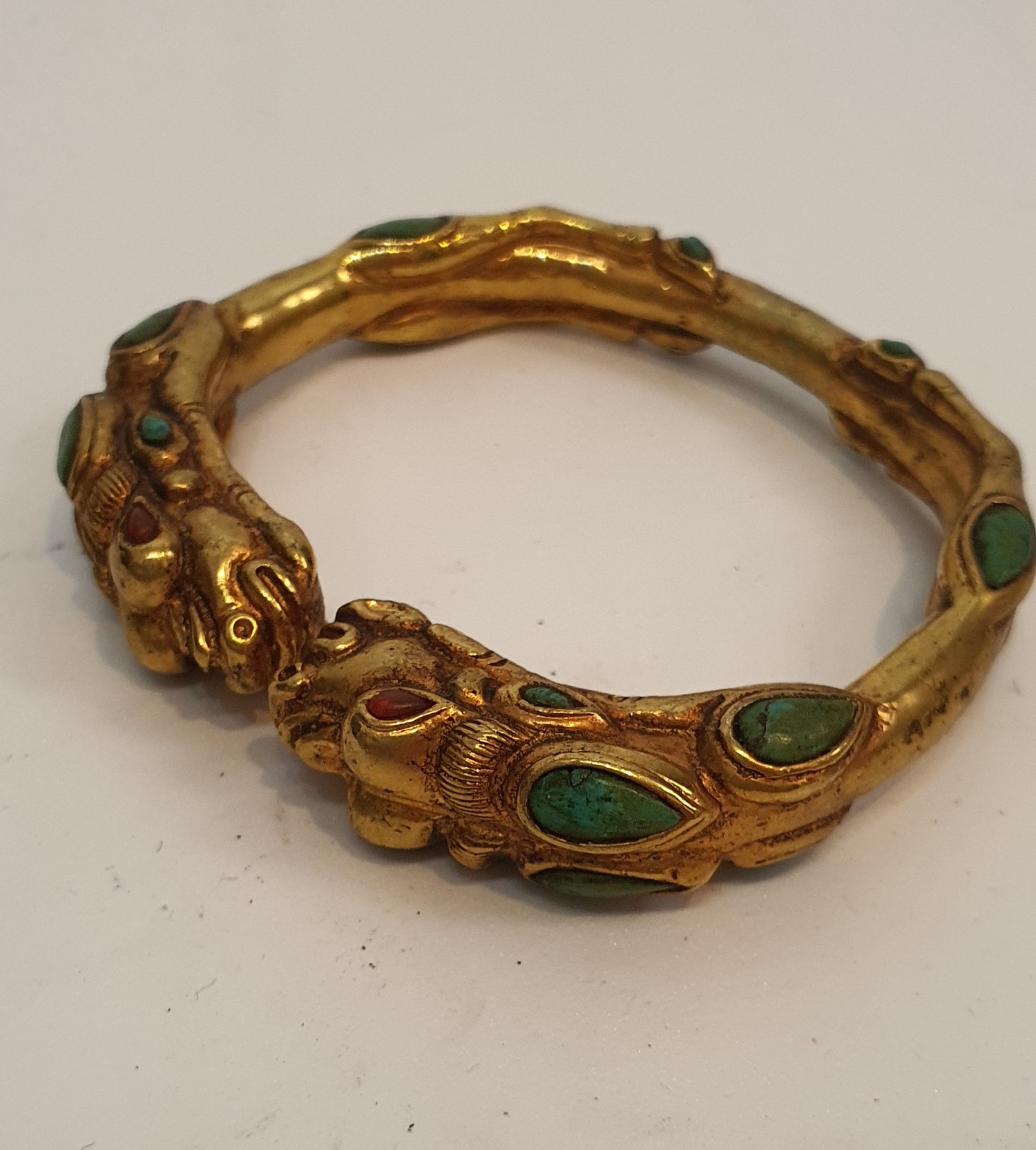 A Tibetan gilded bronze two headed dragon bangle inset with turquoise and red stone cabochons for - Image 2 of 3