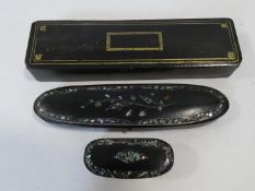 Three antique hand painted black papier-mâché snuff boxes, a glasses case with abalone chip inlaid