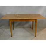 A mid century vintage teak dining table with extra leaf on square tapering supports. H.76 L.154 W.