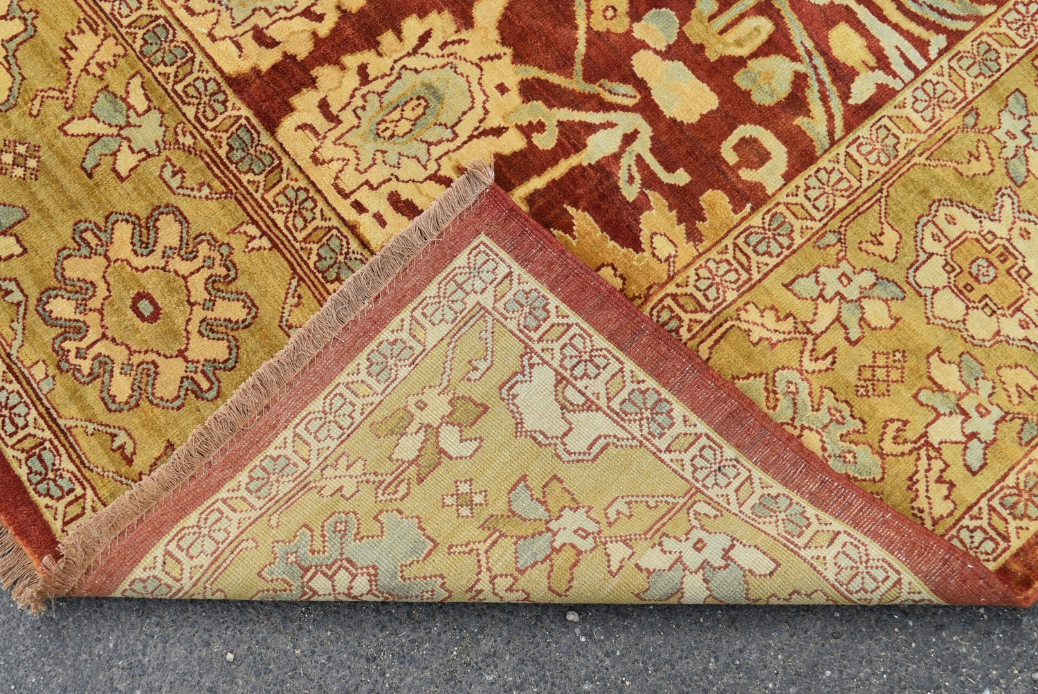 A Ziegler style carpet with repeating meandering vine and palmette design on a deep burgundy - Image 2 of 2