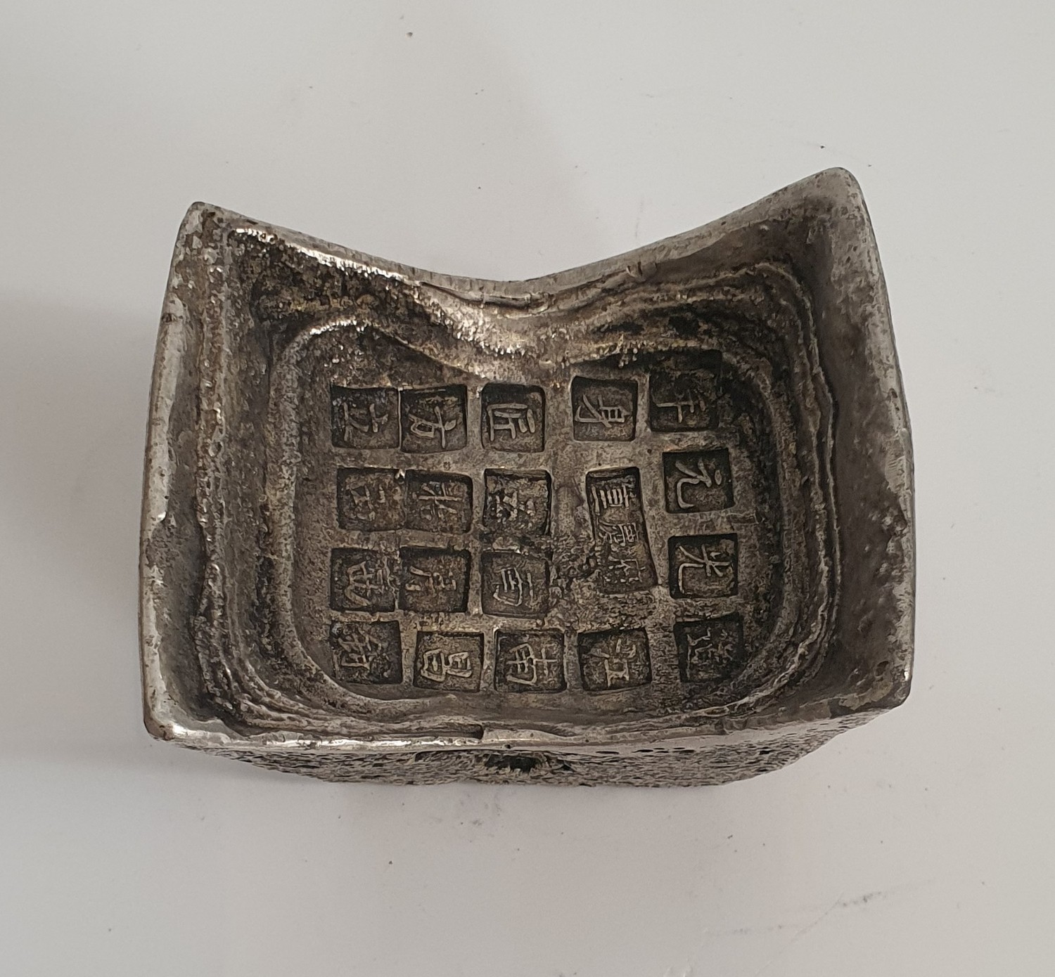 A Chinese white metal yuan bao (ingot) with Chinese characters impressed. H.10xW.6.5cm - Image 3 of 4