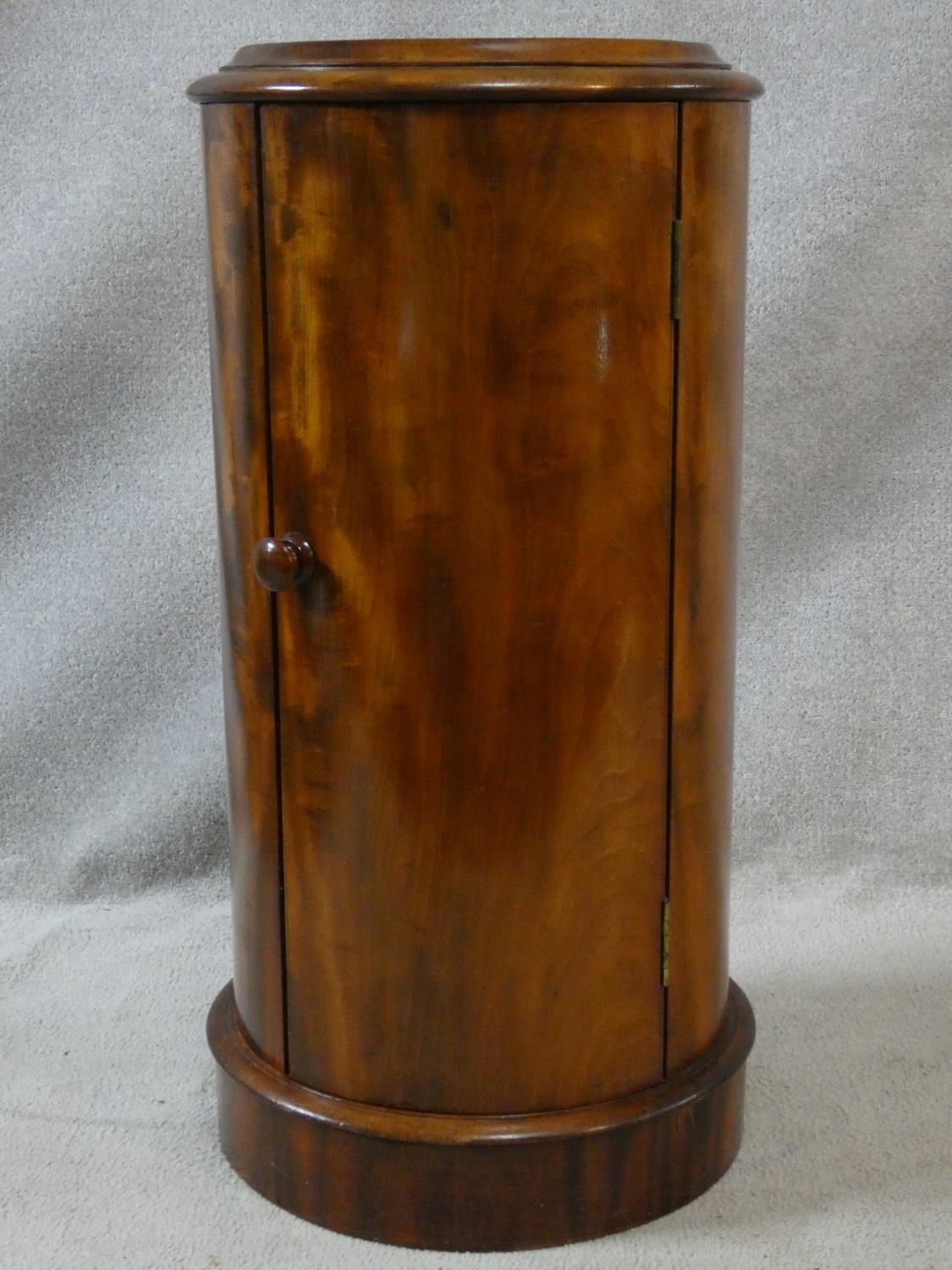 A 19th century mahogany cylindrical pot cupboard with inset marble top on plinth base. H.84 D.43cm