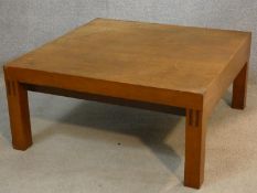 A 1960's vintage teak coffee table on block supports. H.31 L.66 W.66cm
