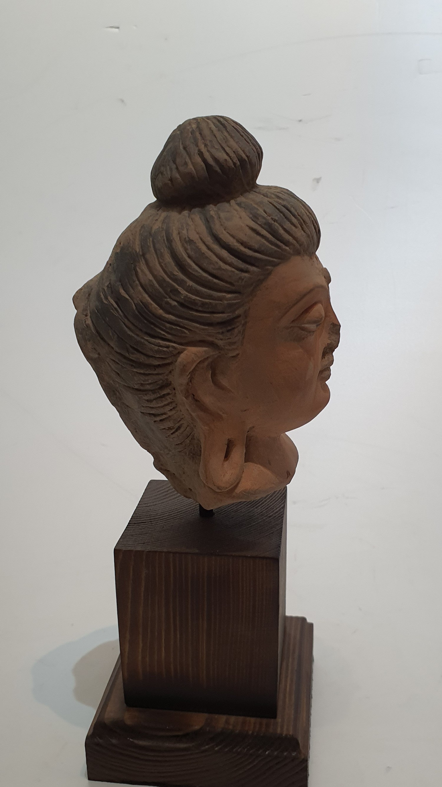 A Chinese terracotta head of buddha with painted details, mounted on a wooden stand. H27cm. - Image 3 of 4