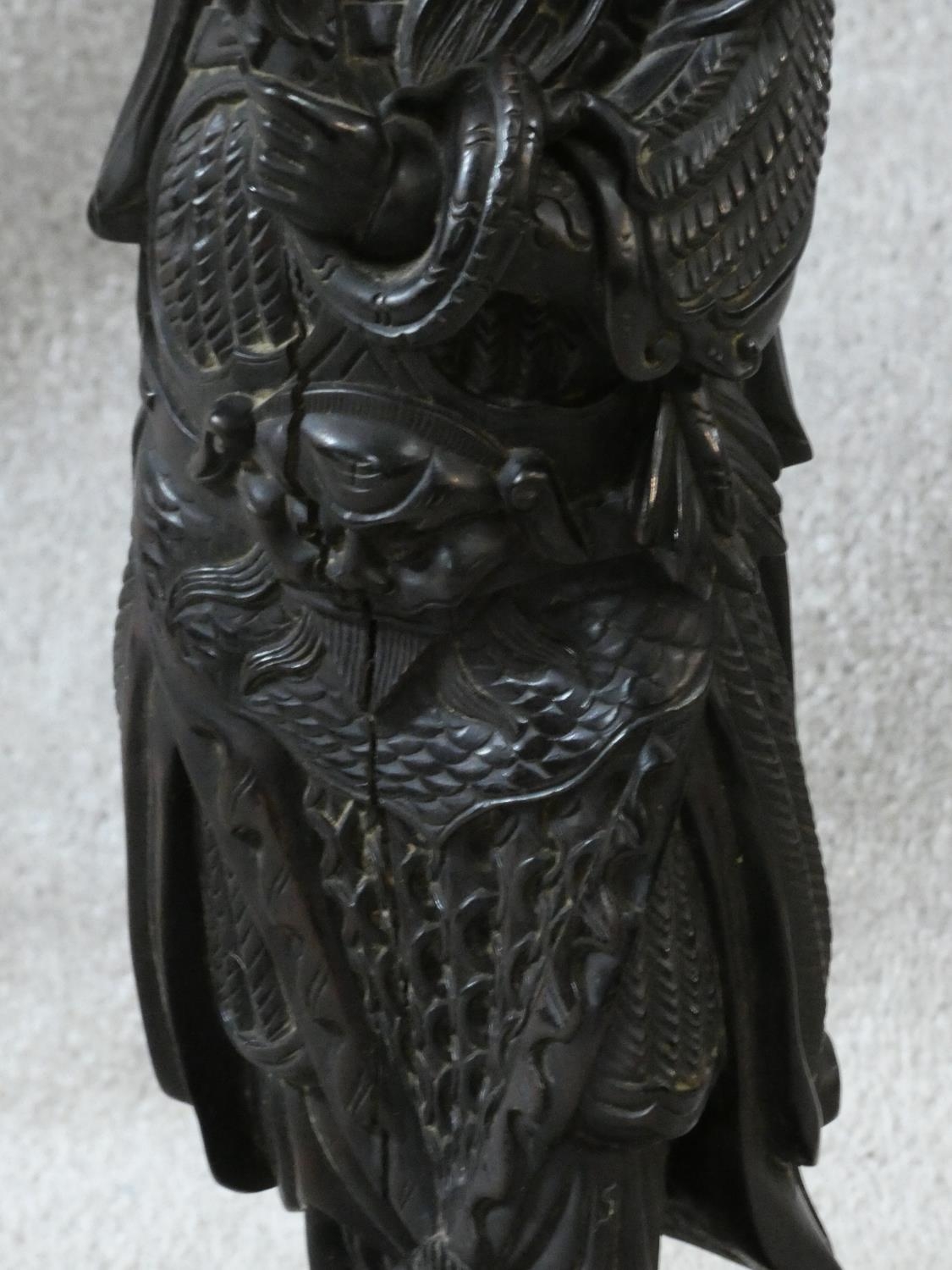 A Chinese carved hardwood figure of an immortal with jade bi disc on silk cord hanging from his - Image 3 of 5
