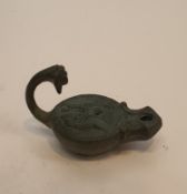 A Roman style bronze oil lamp with animal head finial to the handle and impressed design. H.9cm