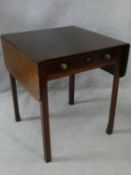 A Georgian mahogany drop flap Pembroke table fitted with frieze drawer on square chamfered supports.