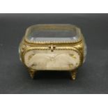 A French antique bevelled glass gilt metal jewellery box with silk button cushion to base. H.8 L.